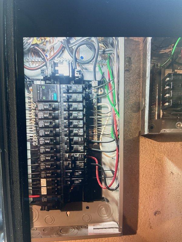 Responded to callback for electrical installation to address code violation. Corrected improper SO cord feeding panel by installing compliant wiring and connections per electrical code requirements. Verified all circuit breakers properly seated and labeled, confirmed wire connections secure at panel bus bars, and ensured proper color-coded wiring throughout distribution system. Panel now meets code compliance standards with appropriate permanent wiring installation.
