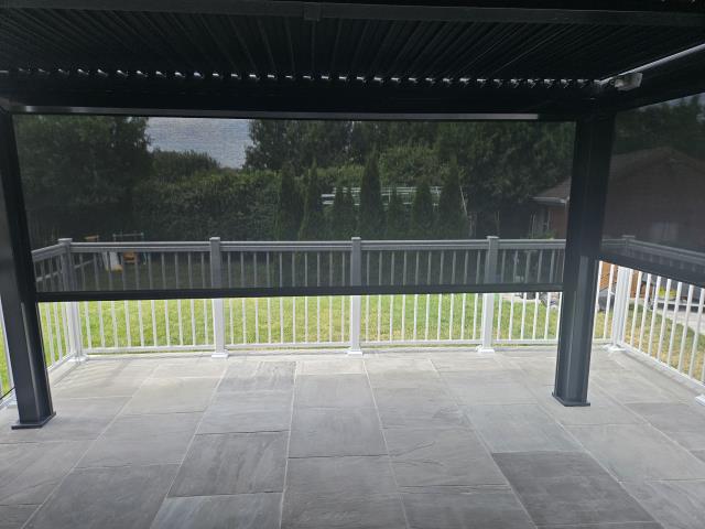 For this returning customer, we previously installed elegant aluminum deck railings that enhanced both the safety and style of their outdoor space. This time, we added motorized zipper system blinds with 3% black fabric. These sleek and functional blinds not only provide shade and protect outdoor furniture from the sun, but also help keep insects out—while offering a touch of privacy for added comfort. For this returning customer, we previously installed elegant aluminum deck railings that enhanced both the safety and style of their outdoor space. This time, we added motorized zipper system blinds with 3% black fabric. These sleek and functional blinds not only provide shade and protect outdoor furniture from the sun, but also help keep insects out—while offering a touch of privacy for added comfort.