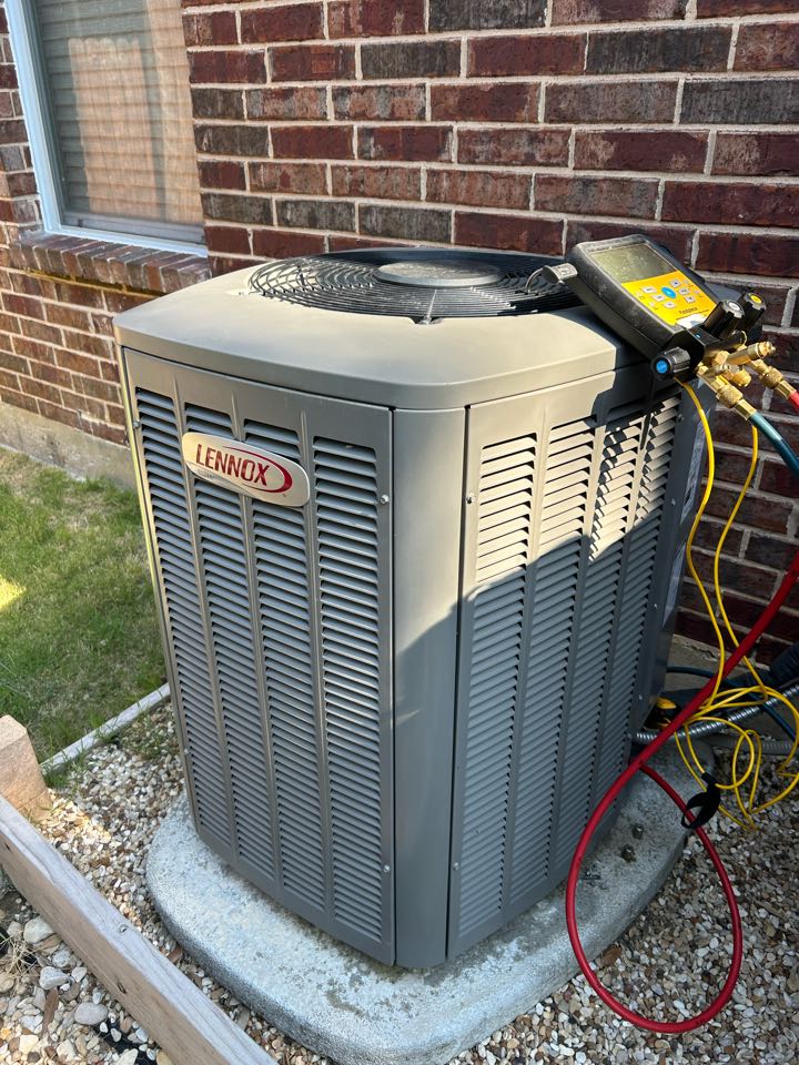 Performing maintenance on a residential HVAC system in Rockwall. 