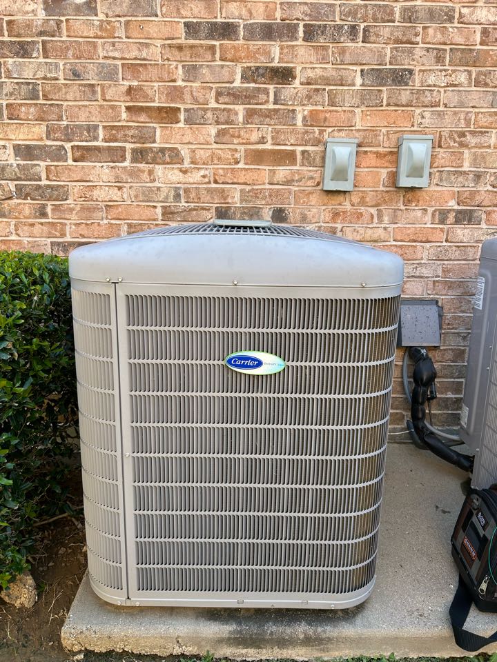 Performing maintenance on residential AC system Lantana, Texas. 