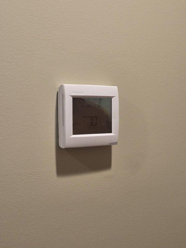 Conducted comprehensive assessment of 18-year-old geothermal system for potential replacement. Inspected existing thermostat installations (Comfort-Aire model showing 64-degree reading and another digital programmable unit) to evaluate compatibility with new system specifications. Provided detailed replacement estimate for complete geothermal system upgrade.