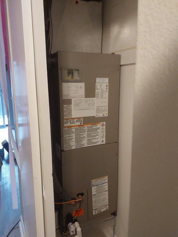 Successfully completed installation of a complete commercial HVAC system, including a Bryant FJA5NXB24LOO 2-ton air handler with 5kw heat pack and GA4SAN524 AC unit with R454B refrigerant. System was relocated to closet space, connected to existing ductwork with custom sheet metal transitions, and verified operational with electrical testing showing proper voltage at 211V AC.