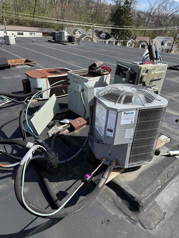 # HVAC Install - Complete System - Commercial

Successfully completed a full commercial HVAC system installation on a rooftop location. Installed a Bryant FJ5ANXA18 air handler unit, Bryant GA4SAN518 1.5-ton air conditioning condenser unit, and 8KW heat pack for apartment heating. Mounted condenser unit on equipment pad with proper clearances and secured all equipment according to manufacturer specifications. 

Ran refrigerant lines between outdoor condenser and indoor air handler using black insulated line sets, ensuring proper routing and support. Installed electrical disconnects, whips, and fuses for safe equipment operation and service access. Fabricated and installed sheet metal ductwork to integrate new air handler with existing return and supply duct systems. 

Completed all electrical connections, refrigerant line connections, and condensate drain piping. Evacuated refrigerant lines, charged system to manufacturer specifications, and verified proper operation of all components 