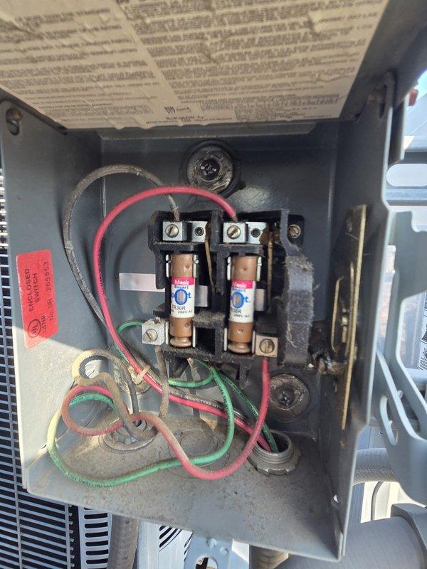 Conducted comprehensive assessment of rooftop HVAC installation featuring three R-22 heat pump systems requiring replacement due to refrigerant depletion in primary unit. Documented existing equipment configuration including multiple condensing units mounted on support frames with electrical disconnects containing aged fuses and wiring. Determined crane access will be necessary for removal and installation of rooftop units given building height and equipment positioning on gravel-surfaced roof.
