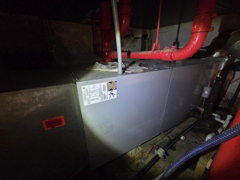 Conducted comprehensive assessment of existing commercial HVAC air handler unit located in basement mechanical room. Documented current equipment configuration including air handler, ductwork connections, PVC condensate drainage system, and proximity to fire suppression piping. Evaluated unit condition, spatial constraints, and mechanical room infrastructure to provide accurate replacement estimate for new commercial air handling equipment.
