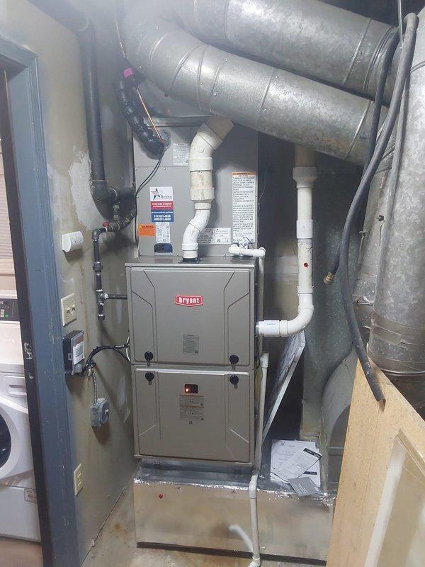 Completed full commercial HVAC system replacement including installation of Bryant Legacy 912SE60100M21 100,000 BTU gas furnace, Bryant Legacy 134SAN04800N 4-ton air conditioner with R454B refrigerant, and CVAVA4821XMA cased vertical evaporator coil. Removed existing deteriorated equipment and constructed new sheet metal return air box to replace rusted original unit with holes and structural drooping. Installed new outdoor condenser pad with gravel base for proper drainage and equipment stability, replaced electrical disconnect box with new fuses, and installed new thermostat for system control. Purged lineset with nitrogen during installation to ensure system cleanliness, reconnected all existing utility connections including drain line, gas line, and flue piping. Installed filter rack for improved maintenance accessibility and completed all electrical, refrigerant, and ductwork connections per manufacturer specifications.