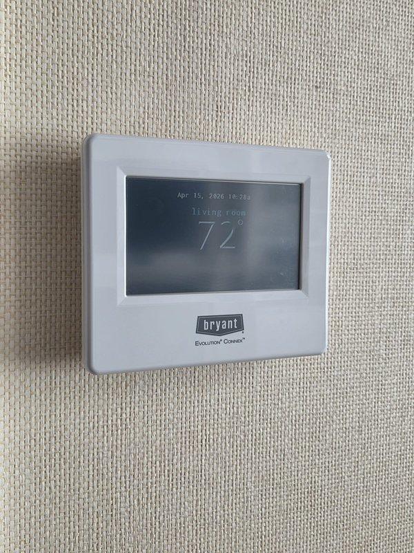 Conducted comprehensive assessment of existing HVAC system serving in-law suite to provide replacement estimate. Evaluated current Bryant furnace and air handler installation in utility closet, documenting equipment specifications, ductwork configuration, and thermostat setup. Inspected Bryant Evolution Connex thermostat, existing condensate drain lines, PVC venting system, and galvanized metal ductwork connections to determine compatibility requirements for new air conditioning unit installation.