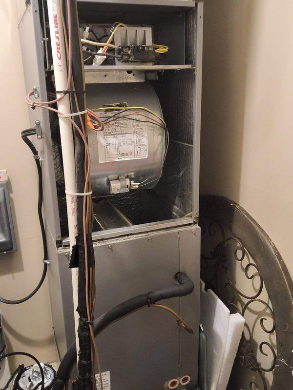 Completed comprehensive HVAC system replacement estimate for residential air handler unit installed in interior utility closet. Assessment included evaluation of existing vertical cabinet-mounted system with blower motor assembly, refrigerant line configuration, electrical connections, and ductwork integration, as well as ceiling access point with exposed wiring infrastructure requiring coordination for new system installation.