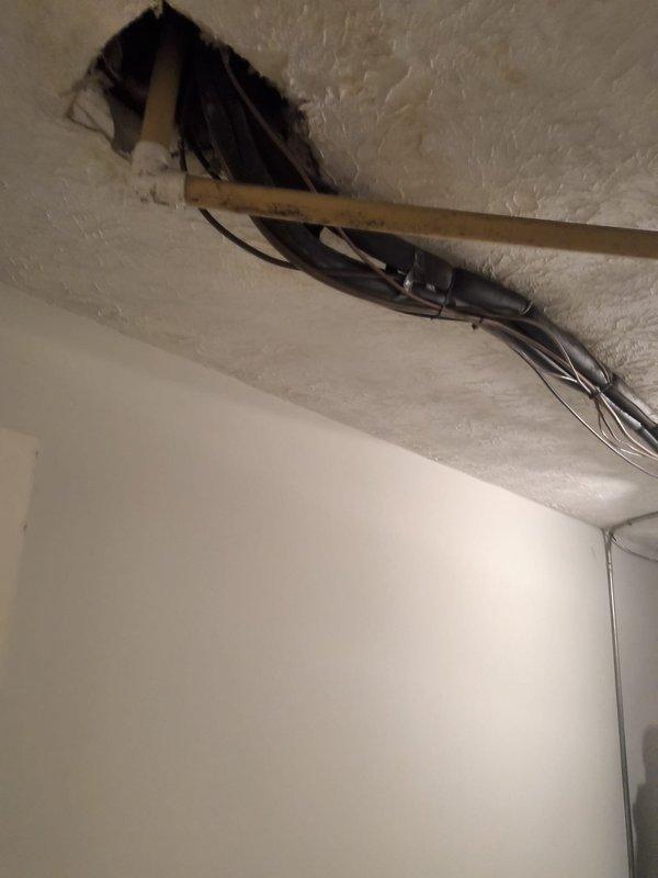 Completed comprehensive HVAC system replacement estimate for residential air handler unit installed in interior utility closet. Assessment included evaluation of existing vertical cabinet-mounted system with blower motor assembly, refrigerant line configuration, electrical connections, and ductwork integration, as well as ceiling access point with exposed wiring infrastructure requiring coordination for new system installation.