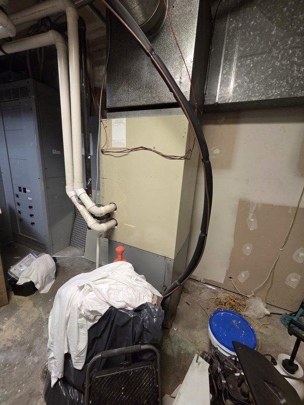 Conducted commercial HVAC replacement estimate at hotel facility. Assessed existing 80,000 BTU furnace system manufactured by Carrier with evaporator coil dated 2016, along with Air Ease condenser unit model AQUA3H24T located in utility closet. Documented system layout with measurements, noted 20x26x1 filter size, and provided replacement recommendations for complete HVAC system upgrade.
