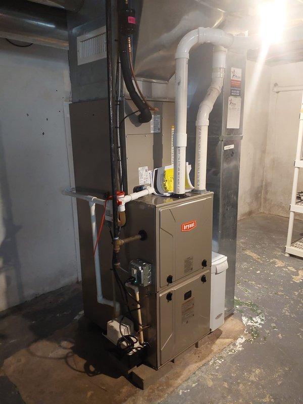 Completed full HVAC system replacement including installation of Legacy 912SE42060M17 92% single-stage gas furnace, Legacy 134SAN03000N 14 SEER2 air conditioner with R454B refrigerant, and CVAVA3017XMA V-coil cased vertical evaporator coil. Performed nitrogen flush of existing lineset, replaced condensate pump, and installed new outdoor equipment pad with new disconnect box and fuses. Reconnected furnace to existing flue pipes and gas line, retained existing humidifier and filter rack, replaced humidifier pad, and installed new thermostat to complete system commissioning.
