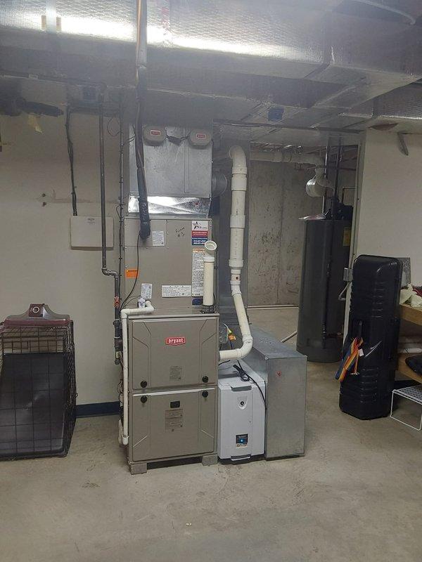 Completed full HVAC system replacement including installation of Bryant 987MC66100C21 Evolution 100,000 BTU gas furnace, 148TAN04800W Preferred 18 SEER2 air conditioner (4.0 tons, two-stage, R454B refrigerant), and CVAVA4821XMA V-coil cased vertical evaporator coil in basement utility room. Performed lineset replacement with nitrogen purge, installed new outdoor disconnect with fuses, and reconnected all utilities including gas line, condensate drain line, and filter rack. Reused existing zoning system, replaced thermostat(s), and installed new Model 501 filter in existing filter rack to complete system commissioning.