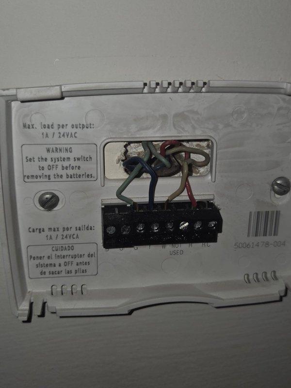Provided comprehensive estimate for complete heat pump system replacement on 20+ year old unit experiencing low refrigerant charge and failed fan motor. Documented existing thermostat wiring configuration and electrical panel setup with photos to ensure proper compatibility and electrical capacity for new equipment installation.
