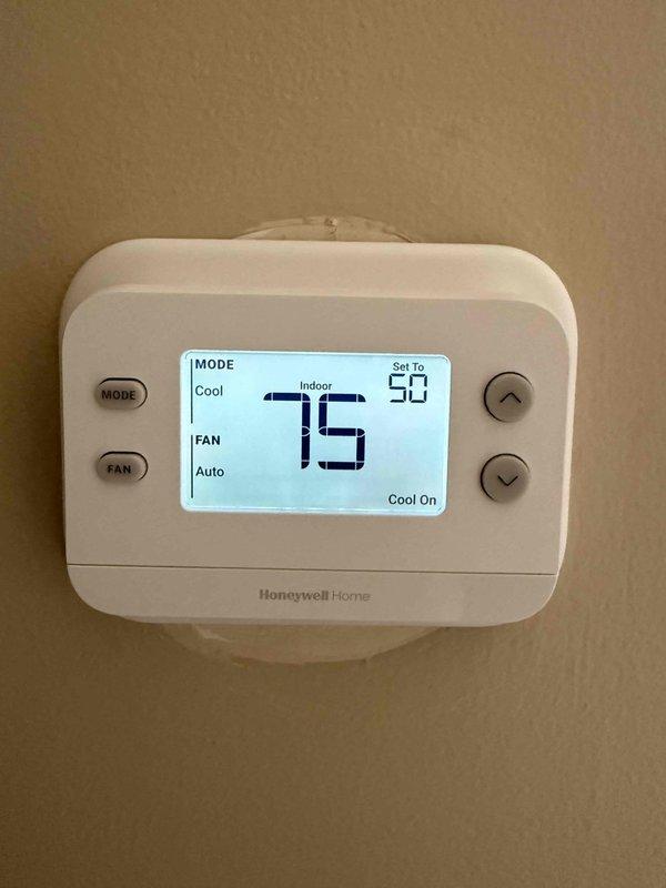 Responded to no cooling complaint following commercial AC installation. Upon arrival, verified thermostat was set to cooling mode with setpoint at 50°F and indoor temperature reading 75°F. Inspected system operation and measured supply air temperature at ceiling diffuser, confirming 55°F discharge air temperature. Checked service valves on outdoor unit that may have been inadvertently left closed during installation. Opened valves to proper operating position, restoring full refrigerant flow to system. System now cooling properly with appropriate temperature differential.