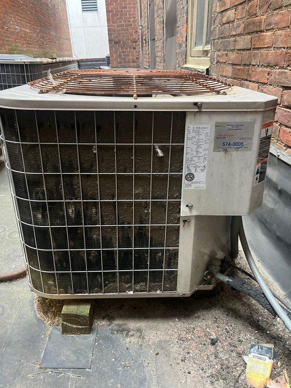Conducted site assessment of existing rooftop R-22 commercial air conditioning system experiencing low refrigerant levels. Evaluated condenser unit condition, noting significant dirt accumulation on protective grille and aged equipment requiring replacement due to obsolete refrigerant type and system deterioration. Provided comprehensive replacement estimate for new commercial HVAC system installation.