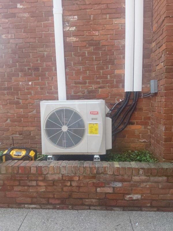 Completed installation of a 1.5-ton Bryant ductless mini-split system for commercial application. Installed outdoor condensing unit on brick ledge with proper mounting, connected three Bryant high-wall indoor air handlers with refrigerant line sets and PVC condensate drainage routed vertically along exterior brick wall. Performed system startup, charged refrigerant to manufacturer specifications, tested all zones with digital manifold gauges to verify proper pressures and temperatures, and confirmed operational status of all thermostats and indoor units.