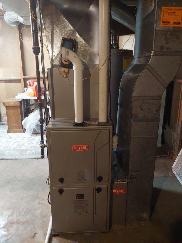 Completed full HVAC system installation including Legacy 912SE42060M17 92% single-stage gas furnace, Legacy 134SAN02400N 14 SEER2 air conditioner with R454B refrigerant, and CVAVA2417XMA v-coil cased vertical evaporator coil. Replaced existing lineset, installed new outdoor condenser pad and disconnect box with fuses, replaced filter rack, and rebuilt partial return drop (24×8). Reconnected all systems to existing drain line, gas line, and flue pipes while retaining existing thermostat.