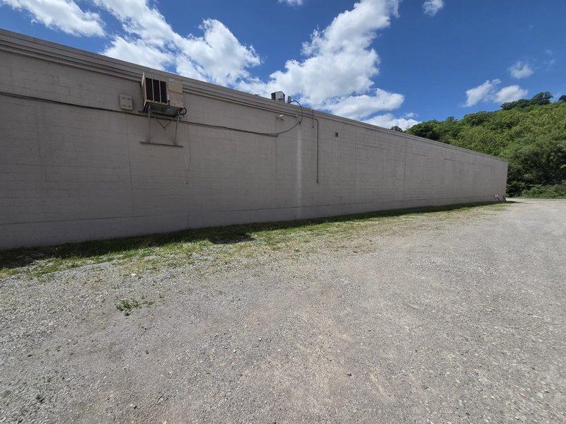 Conducted site assessment for commercial packaged HVAC unit replacement. Documented existing electrical disconnect panel serving A/C Unit #4 with Square D breaker configuration and inspected exterior wall-mounted package unit on commercial building. Provided comprehensive replacement estimate for complete system installation.
