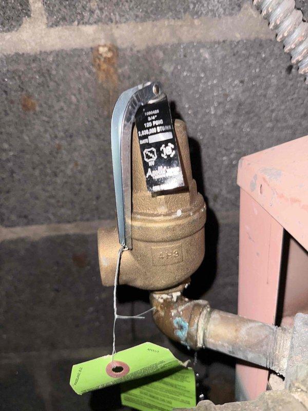 Responded to commercial boiler not working call and performed diagnostic inspection of the main boiler system. Inspected and documented Apollo pressure relief valve assembly, verifying proper installation and operational status of the brass valve body with lever handle. Confirmed all safety components, copper piping connections, and valve identification tags were present and properly labeled for maintenance tracking purposes.
