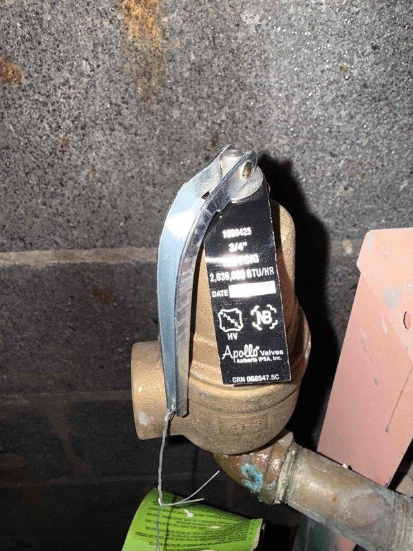 Responded to commercial boiler not working call and performed diagnostic inspection of the main boiler system. Inspected and documented Apollo pressure relief valve assembly, verifying proper installation and operational status of the brass valve body with lever handle. Confirmed all safety components, copper piping connections, and valve identification tags were present and properly labeled for maintenance tracking purposes.