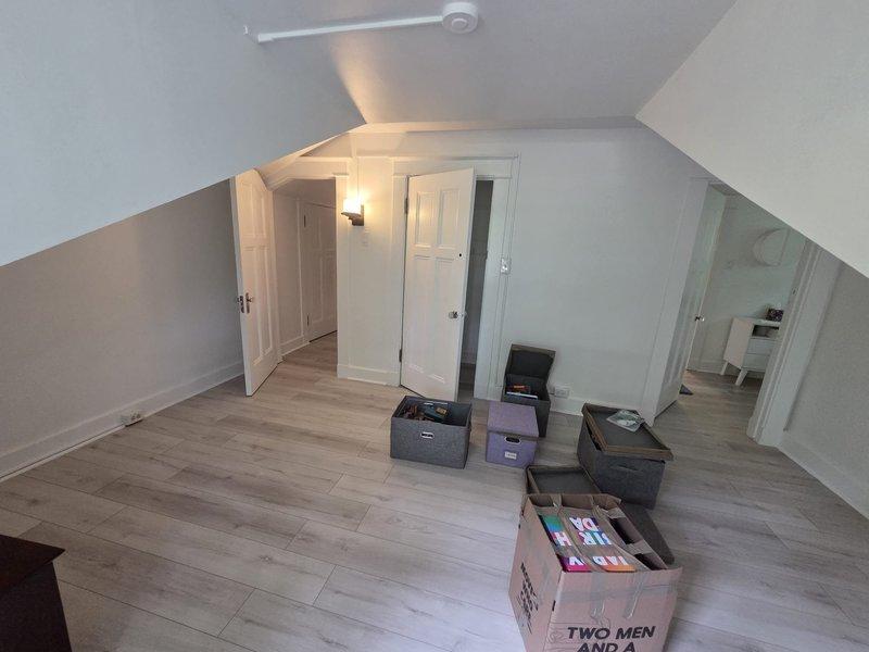 Conducted site assessment for mini-split installation in finished attic space with sloped ceilings and multiple rooms. Evaluated electrical panel capacity and photographed existing infrastructure to determine equipment requirements and installation specifications for proposed ductless system.