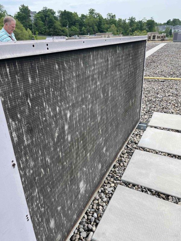 Conducted rooftop estimate for replacement of original 20+ year-old RTU at a school/daycare facility that had ceased operation. Documented existing equipment condition showing heavily soiled condenser coil with significant dirt and debris accumulation, extensive streaking and discoloration on exterior panels, and overall deterioration consistent with age and end of service life. Coordinated roof access and assessed replacement requirements for commercial rooftop unit.