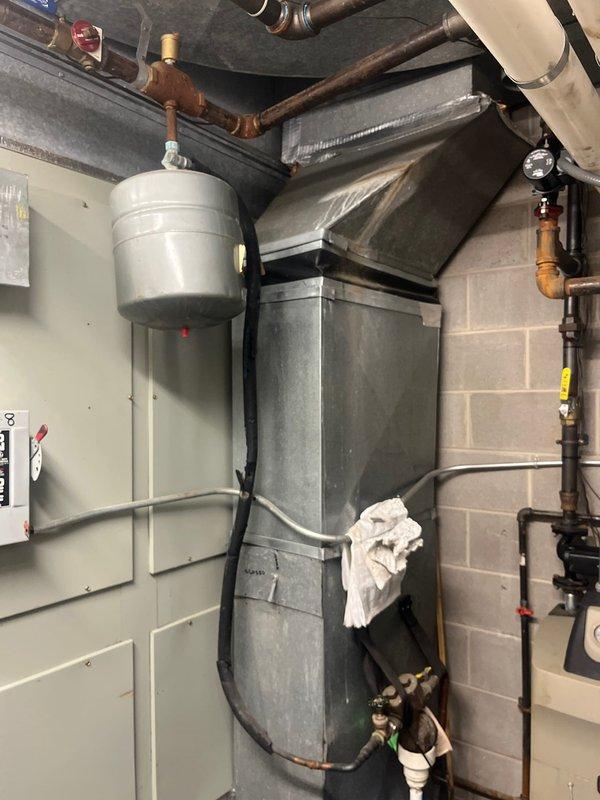 Conducted comprehensive assessment of commercial HVAC system designated as Unit 3 to provide replacement estimate for air conditioning and gas furnace equipment. Evaluated existing cabinet-style air handler unit, associated ductwork, expansion tank, copper piping infrastructure, electrical disconnect components, and mechanical room configuration. Documented current system conditions including equipment age, operational status, and integration with building plumbing and electrical systems. Photographed all relevant equipment, piping connections, control boxes, and utility space layout to support accurate replacement specifications and installation planning.