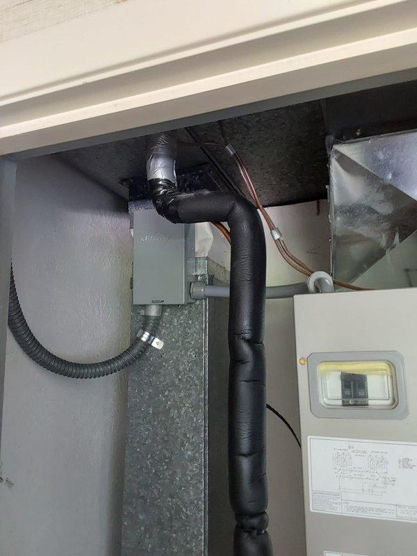 Responded to inspection correction for heat pump #1 requiring proper electrical disconnect and fuse sizing. Verified NEC and Residential Code of Ohio requirements mandating that hardwired HVAC equipment must have a disconnect unless located within 25 feet AND within sight of the main electrical service panel. Installed outdoor weatherproof disconnect box with 25-amp cartridge fuses for heat pump #1, mounted on exterior concrete pad adjacent to cinder block wall. Confirmed proper fuse sizing, grounding connections, and wiring configuration per code specifications. Assessed all air handler locations and determined none meet the criteria for disconnect exemption based on distance and line-of-sight requirements from main panel. Documented installation with photos showing completed disconnect installation with proper fuse protection and interior air handler electrical connections.