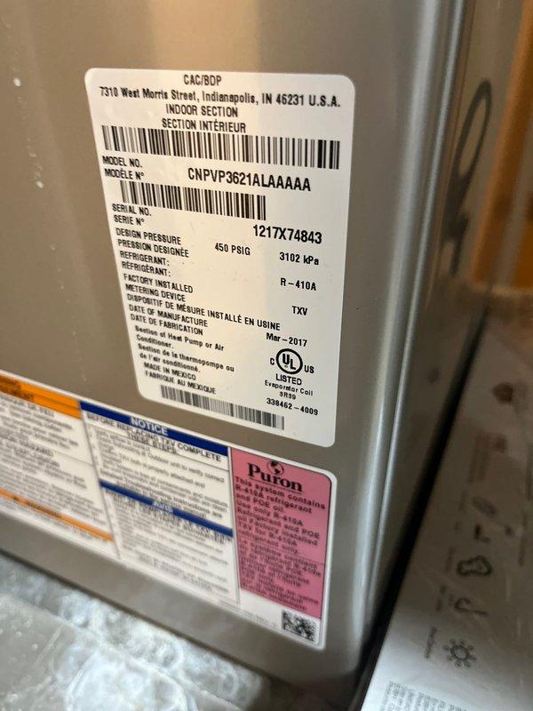 Completed estimate for complete HVAC system replacement in basement mechanical room. Evaluated existing indoor air handler unit model CNPVP3621ALAAAAA manufactured March 2017 utilizing R-410A refrigerant, along with furnace and associated Bryant equipment. Documented current system configuration including PVC venting, copper refrigerant lines, electrical connections, and overall installation conditions to provide replacement options and specifications.
