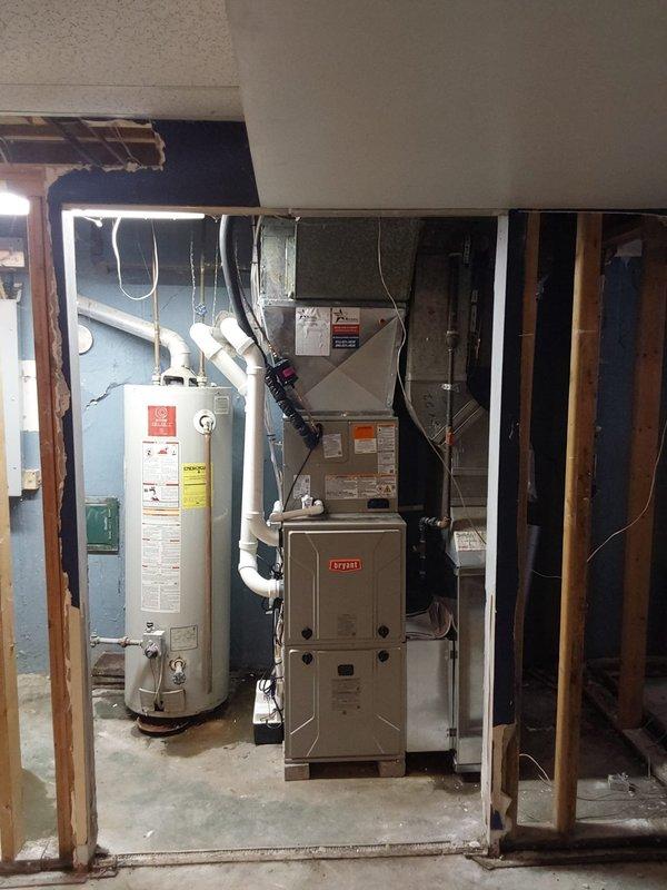 Completed full HVAC system replacement in basement mechanical room including installation of Bryant Legacy 912SE42060M17 gas furnace, Bryant Legacy 134SAN02400N air conditioner with R454B refrigerant, and CVAVA2417XMA cased vertical evaporator coil. Installed Bryant bypass humidifier with wet switch overflow protection, Honeywell FocusPRO P200 thermostat, and Bryant 16x25x4 media filter kit. All refrigerant lines, condensate drainage, electrical connections, and ductwork modifications completed per manufacturer specifications. Exterior condensing unit positioned and connected with proper venting through foundation wall. System tested, balanced, and confirmed operational with all safety controls functioning properly.