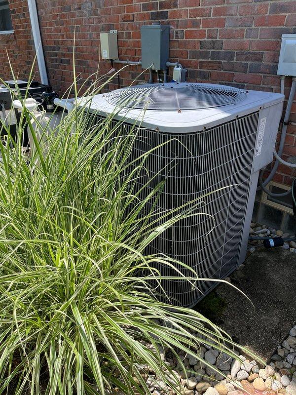 Conducted comprehensive site evaluation for complete HVAC system replacement at residential property. Assessed existing outdoor condenser unit positioned against brick exterior wall, documenting current equipment configuration including electrical disconnect boxes, conduit routing, and mounting location. Photographed equipment placement in relation to landscaping features, concrete pad condition, and clearance requirements for proper airflow and serviceability. Evaluated accessibility for removal of existing unit and installation of replacement equipment, noting ornamental grass plantings and river rock landscaping that may require temporary relocation during changeout. Documented electrical service components mounted on exterior wall to determine compatibility with proposed replacement system. Prepared detailed estimate for full system replacement including equipment specifications, installation requirements, and necessary modifications to existing infrastructure.