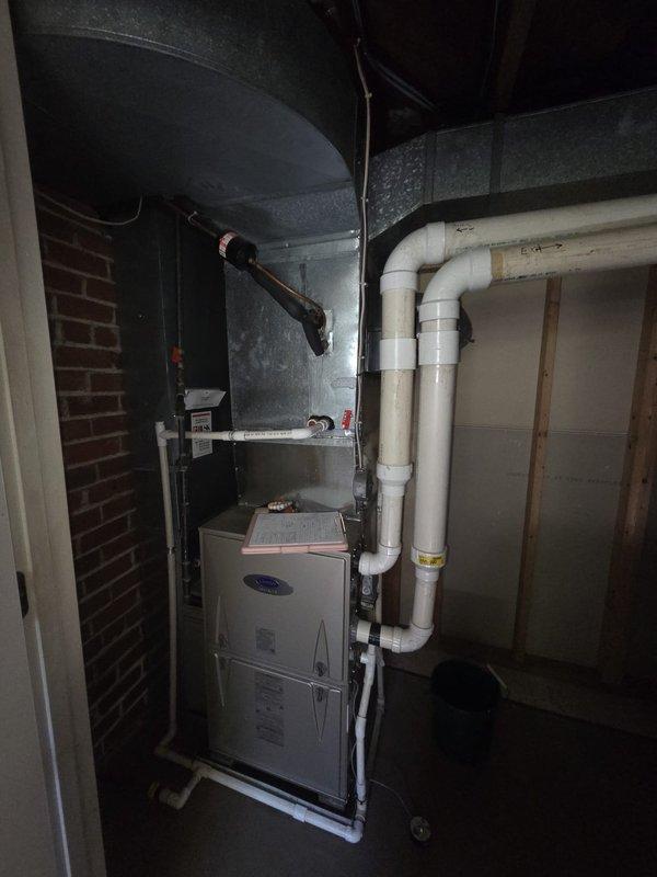 Conducted comprehensive evaluation of existing residential HVAC system for complete replacement estimate. Assessed current furnace installation in basement utility area, including existing PVC venting and drainage configuration, refrigerant line routing, and ductwork layout. Documented electrical service panel configuration and available breaker capacity for new equipment installation requirements.