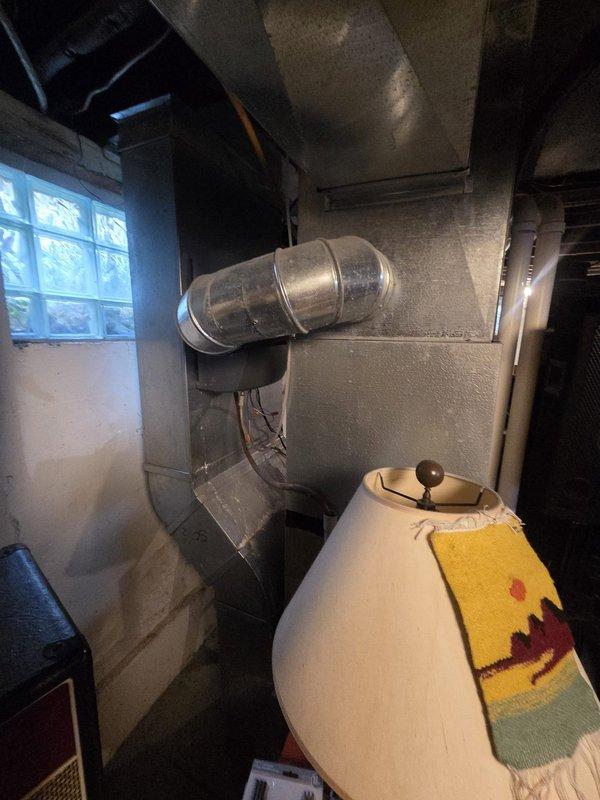 Conducted comprehensive estimate for complete air conditioning system replacement following previous service call that identified low refrigerant levels. Evaluated existing outdoor condenser unit and indoor air handler system, documented current equipment condition including overgrown vegetation obstructing condenser airflow, and assessed ductwork configuration in basement utility area. Provided replacement options and recommendations to address system deficiencies.
