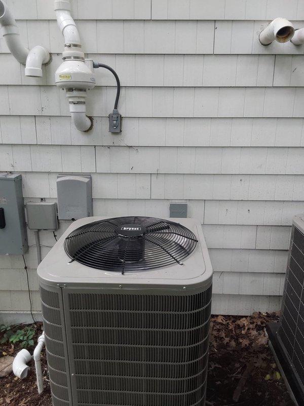 Completed dual-zone HVAC installation consisting of two 146SAN air conditioning systems (3.0-ton and 5.0-ton single-stage units utilizing R454B refrigerant) with corresponding CVAVA V-coil cased vertical evaporator coils installed in interior utility closet alongside existing furnace. Both outdoor condensing units positioned on exterior foundation pad with proper refrigerant line sets, electrical connections, condensate drainage routing via PVC piping, and all systems tested for proper operation and refrigerant charge.