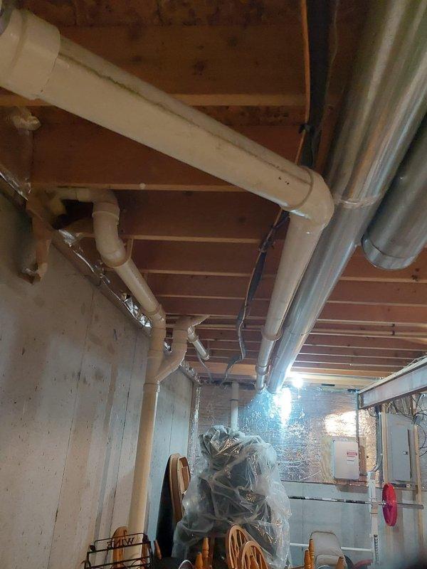 Completed full HVAC system replacement including installation of Bryant 927TA60100V21 Preferred gas furnace, Bryant 148TAN03600W 3.0-ton two-stage air conditioner with R454B refrigerant, and CVAVA3621XMA V-coil cased vertical evaporator coil. Installed approximately 30 feet of new PVC flue piping to exterior, performed nitrogen flush and pressure leak test on linesets, removed existing support poles and installed new outdoor condenser pad, and installed new disconnect box with fuses. Replaced filter rack with new filters, installed Bryant bypass humidifier with new water pads, reconnected all gas and drain lines, and installed new Ecobee thermostat to complete system commissioning.