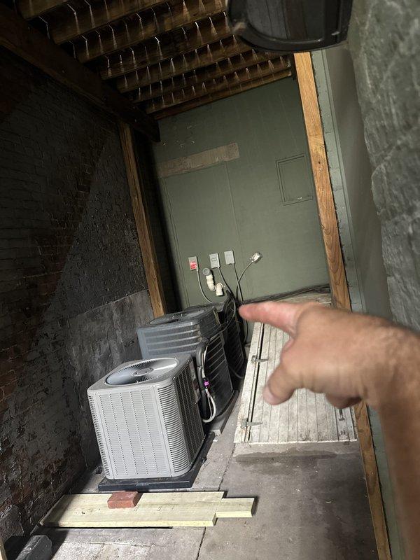 Responded to no cooling complaint at commercial facility. Upon inspection, discovered outdoor condenser unit with associated electrical disconnect and indoor HVAC components including circulation pump system. Documented extensive rust and corrosion on interior metal panels and piping, indicating prolonged moisture exposure that could compromise system integrity and performance. Photographed equipment condition for maintenance records.