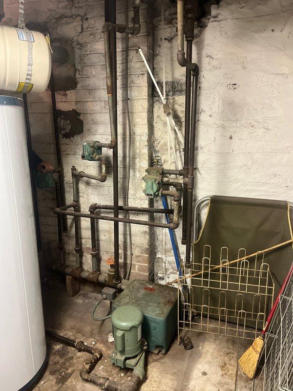 Removed and disposed of existing boiler system from basement mechanical room. Installed new Weil McLain LGB-4 atmospheric gas boiler with steam trim, completing all near boiler piping to manufacturer's specifications. Replaced four 17C thermostatic radiator controls throughout the property to ensure proper system operation and temperature regulation.