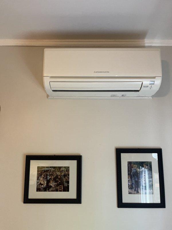 Conducted on-site evaluation for mini-split system replacement. Assessed existing Mitsubishi Electric wall-mounted indoor unit and reviewed installation configuration including exposed PVC piping, flexible ductwork, and electrical connections in adjacent utility closet space. Documented current system setup and provided estimate for replacement equipment and installation.