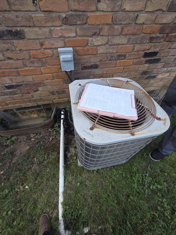 Conducted comprehensive estimate for replacement of 17-year-old residential air conditioning system. Inspected outdoor condenser unit showing significant age-related deterioration including rust staining on casing and general weathering, documented existing thermostat wiring configuration with yellow, red, white, and blue wire connections, and photographed current system condition to provide accurate replacement recommendations.