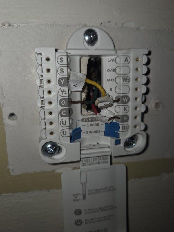 Conducted comprehensive estimate for replacement of 17-year-old residential air conditioning system. Inspected outdoor condenser unit showing significant age-related deterioration including rust staining on casing and general weathering, documented existing thermostat wiring configuration with yellow, red, white, and blue wire connections, and photographed current system condition to provide accurate replacement recommendations.