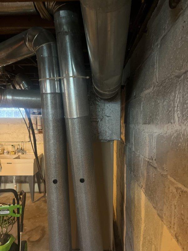 Conducted on-site evaluation for boiler removal and system replacement. Assessed existing basement boiler installation, including vertical ductwork configuration with galvanized and metallic ducts mounted against concrete block wall. Inspected current HVAC air handler unit located in attic space with associated flexible ductwork, PVC condensate drainage, and electrical connections. Documented equipment specifications, spatial constraints, and mechanical system layout to provide comprehensive replacement options. Photographed existing installations to support estimate preparation for complete system conversion.