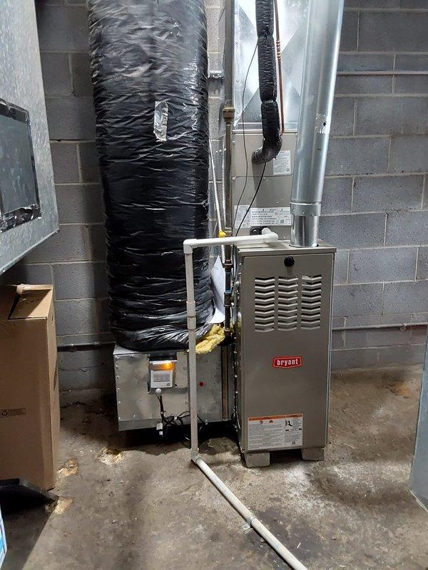 Completed full commercial HVAC system installation including Bryant 800SB36045M14 Legacy gas furnace in basement utility area, Legacy 134SAN 2.0-ton single-stage air conditioning condenser unit on rooftop, and CVAVA3014XMA V-coil cased vertical evaporator coil utilizing R454B refrigerant. Installed and connected all ductwork, refrigerant lines, condensate drainage, electrical connections, and gas piping to manufacturer specifications, with system tested and verified operational.