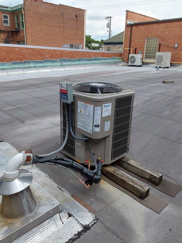 Completed full commercial HVAC system installation including Bryant 800SB36045M14 Legacy gas furnace in basement utility area, Legacy 134SAN 2.0-ton single-stage air conditioning condenser unit on rooftop, and CVAVA3014XMA V-coil cased vertical evaporator coil utilizing R454B refrigerant. Installed and connected all ductwork, refrigerant lines, condensate drainage, electrical connections, and gas piping to manufacturer specifications, with system tested and verified operational.