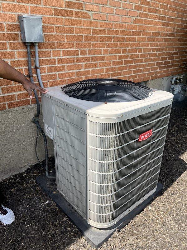 Performed site assessment of existing Bryant air conditioning condenser unit for commercial replacement estimate. Evaluated two replacement options: replacing unit in current ceiling-mounted location versus relocating system outdoors. Documented existing equipment configuration, electrical service panel with Square D breakers, refrigerant line routing, and outdoor installation conditions including concrete pad placement and disconnect box positioning.