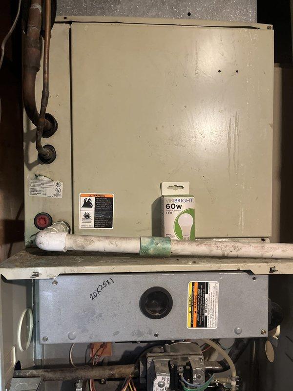 Conducted commercial HVAC replacement estimate for existing air handler unit located in mechanical room. Documented current equipment condition showing aged beige metal cabinet with visible wear, copper refrigerant lines, and existing electrical connections. Unit displays model information and specifications on manufacturer label, with serial number 290541 marked on lower gray panel section. Equipment assessment included evaluation of refrigerant line connections, mounting configuration, electrical components, and surrounding infrastructure to determine replacement requirements and specifications for new commercial-grade air handler installation.