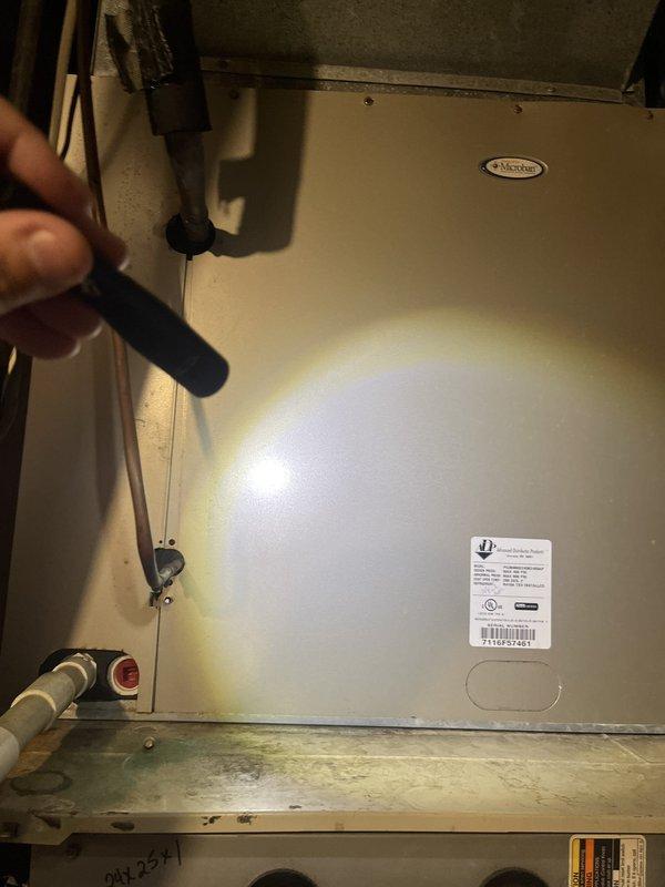 Conducted commercial HVAC replacement estimate for existing air handler unit located in mechanical room. Documented current equipment condition showing aged beige metal cabinet with visible wear, copper refrigerant lines, and existing electrical connections. Unit displays model information and specifications on manufacturer label, with serial number 290541 marked on lower gray panel section. Equipment assessment included evaluation of refrigerant line connections, mounting configuration, electrical components, and surrounding infrastructure to determine replacement requirements and specifications for new commercial-grade air handler installation.