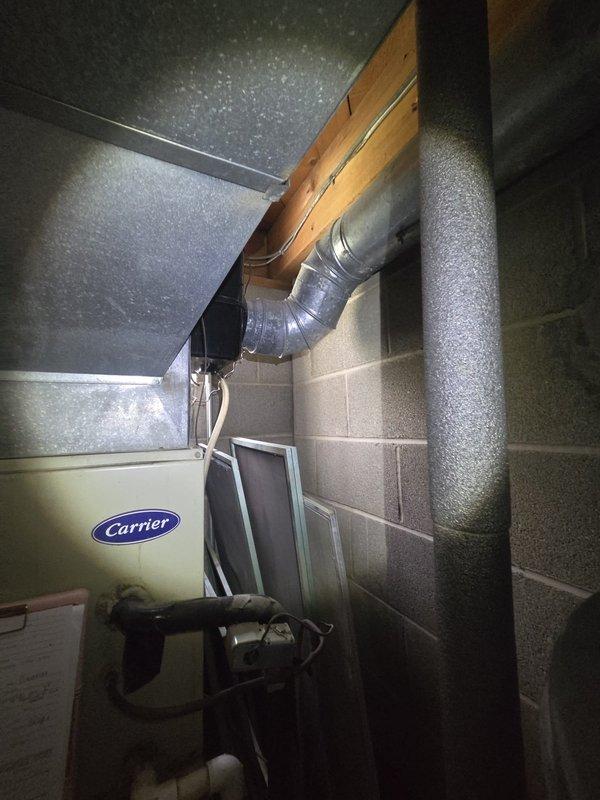 Conducted comprehensive estimate for complete HVAC system replacement of 30-year-old existing furnace and air conditioning equipment. Evaluated current Carrier heating unit and associated ductwork installation in basement utility area, noting standard flexible duct connections and refrigerant line configurations. Provided two separate equipment replacement quotes per customer request: one option maintaining existing outdoor condenser location and an alternative option relocating the outdoor AC unit to the east side of the residence. Documented existing system configuration including furnace positioning, PVC venting, electrical connections, and current ductwork layout to determine optimal replacement specifications and installation requirements.