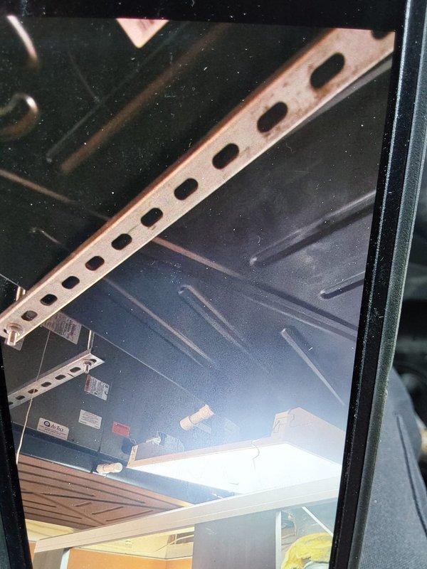 Installed drip pans on commercial HVAC air handling unit located in confined mechanical space. Accessed equipment compartment, positioned and secured drip pans beneath evaporator coil assembly using appropriate mounting brackets and hardware to prevent condensate overflow and potential water damage. Work completed on time and material basis with all components properly installed and secured.