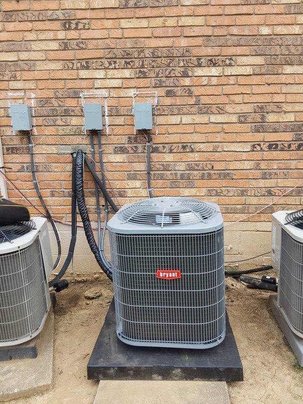 Completed full commercial HVAC system installation consisting of Bryant FJ5ANXA18L00 air handler with 10 kW heating element and Bryant GA4SAN518 outdoor condensing unit. Installed air handler in interior utility space with proper ductwork connections including metallic plenum and flexible ducting at supply outlet. Ran and terminated electrical wiring from wall-mounted disconnect to air handler, securing all conduit and wiring per code requirements. Installed PVC condensate drain lines from air handler base with proper pitch and termination. Mounted outdoor condensing unit on concrete pad against exterior brick wall alongside existing HVAC equipment. Installed electrical disconnect box on brick wall with conduit run to condensing unit. Connected refrigerant line set between indoor and outdoor units. Installed whip connection and fuses at disconnect location. Verified all electrical connections, tested system operation, and confirmed proper airflow and drainage.