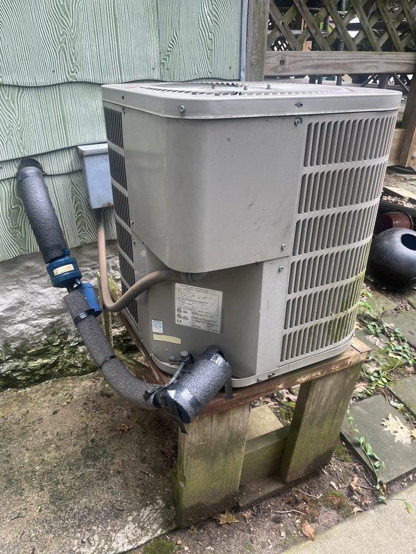 Completed on-site estimate for complete HVAC system replacement. Evaluated existing outdoor condensing unit mounted on wooden platform against exterior wall with insulated refrigerant lines and service valves, noting weathered installation conditions. Assessed indoor furnace system in basement mechanical room including metal cabinet unit, plenum assembly with X-pattern bracing, and ductwork connections. Provided comprehensive replacement options for both heating and cooling equipment.